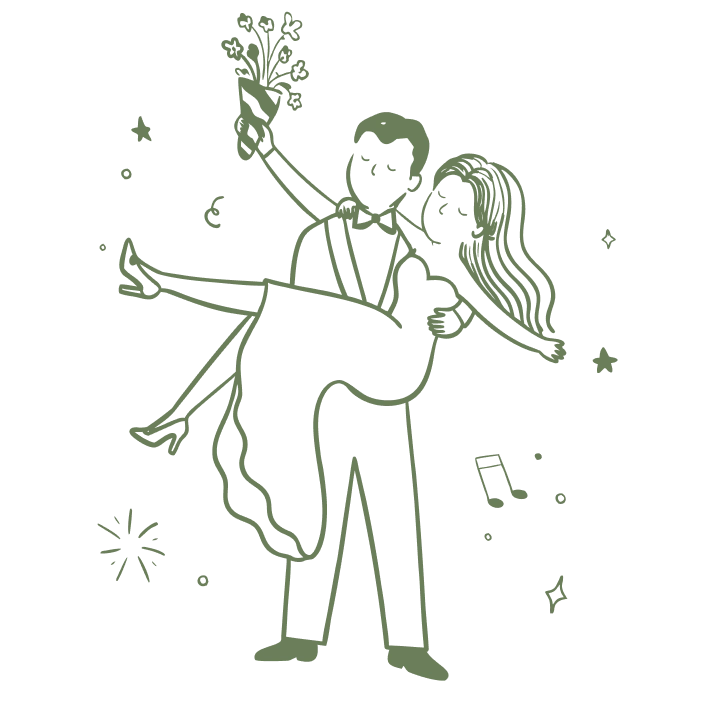 The groom carrying the bride, holding a bouquet in the air.